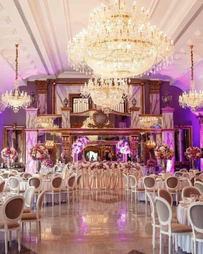 Luxurious dinner hall with large crystal chandeliers hanging from the ceiling